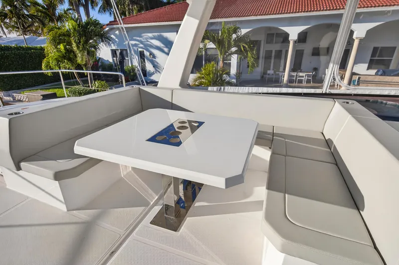 Slide: The Image of 2024 Leopard 46 Powercat yacht with elegant outdoor seating and table setup. - 27