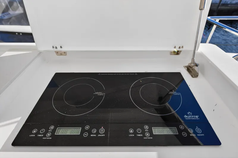Slide: The Image of Induction cooktop on 2024 Leopard 46 Powercat yacht, featuring dual burners and digital controls. - 31