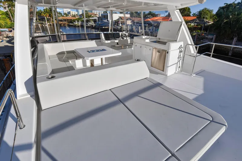Slide: The Image of 2024 Leopard 46 Powercat yacht deck with seating, table, and kitchenette. - 33