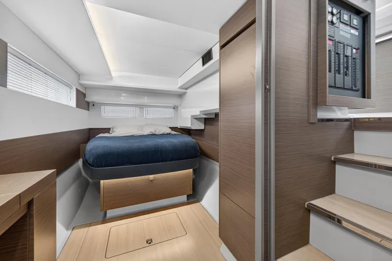 Slide: The Image of 2024 Leopard 46 Powercat interior cabin with modern wood finishes and cozy bed. - 37