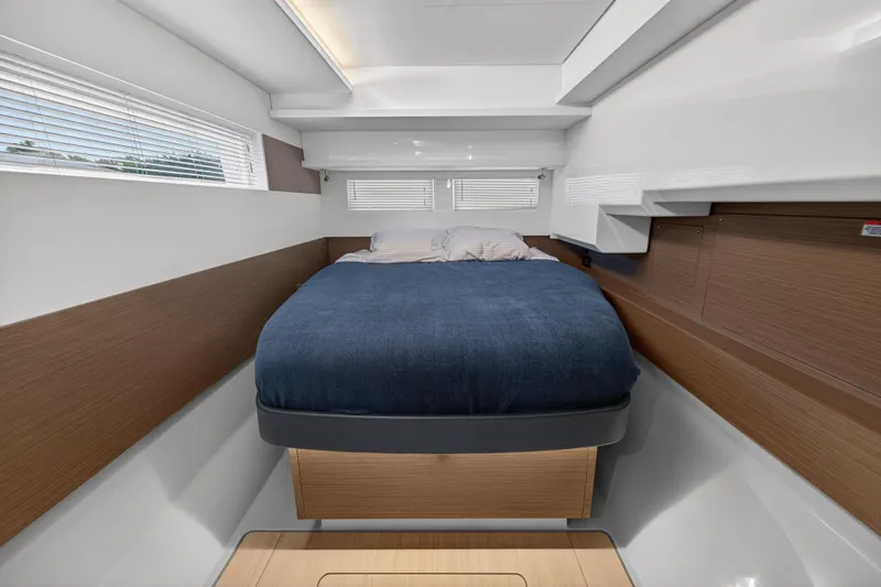 Slide: The Image of 2024 Leopard 46 Powercat cabin with modern design, featuring a cozy bed and sleek wood accents. - 38