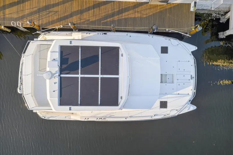 Slide: The Image of 2024 Leopard 46 Powercat yacht with solar panels, docked aerial view. - 4