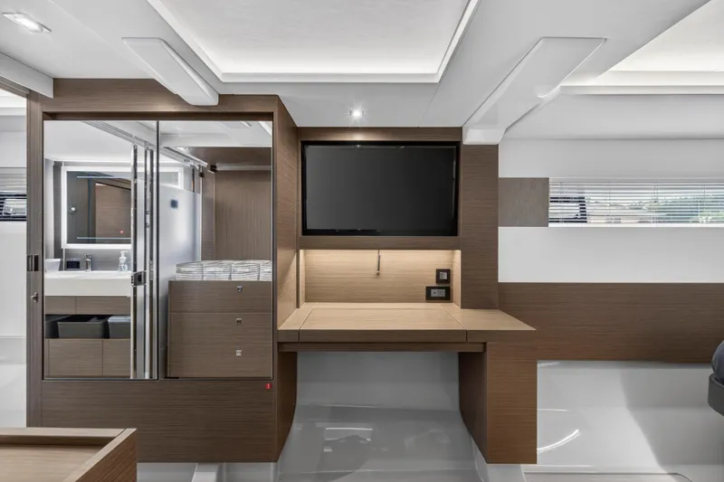 Slide: The Image of Modern interior of 2024 Leopard 46 Powercat with sleek wood finishes and built-in TV. - 40