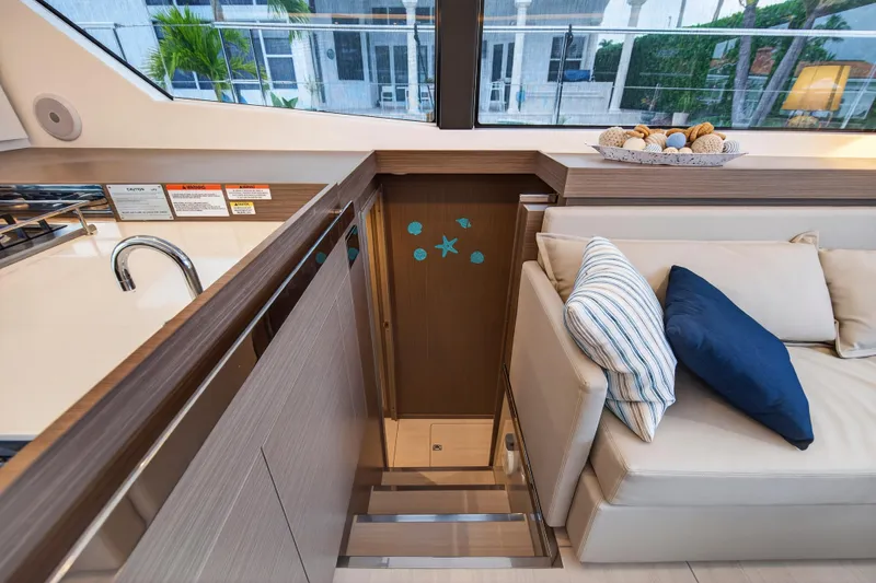 Slide: The Image of 2024 Leopard 46 Powercat interior with modern kitchen and cozy seating area. - 48