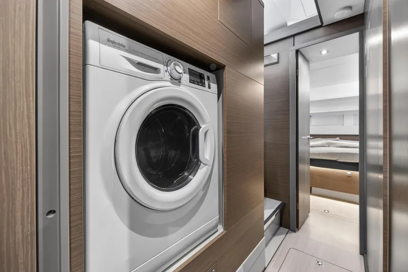 Slide: The Image of Laundry area inside 2024 Leopard 46 Powercat yacht, featuring a modern washing machine. - 50