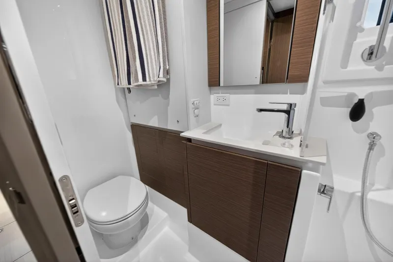 Slide: The Image of Modern bathroom in 2024 Leopard 46 Powercat yacht with sleek fixtures and wood accents. - 56