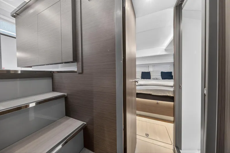 Slide: The Image of 2024 Leopard 46 Powercat interior with modern design, featuring stairs and a cozy bedroom. - 58