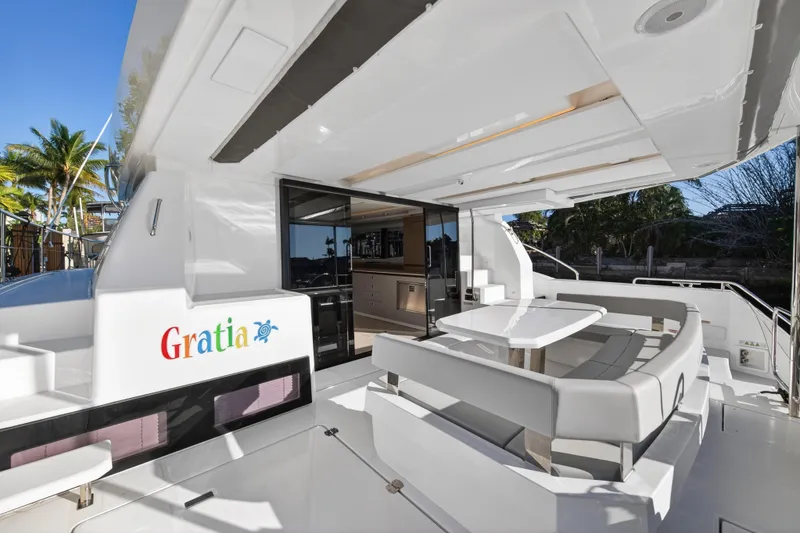 Slide: The Image of 2024 Leopard 46 Powercat yacht with outdoor seating and sleek design. - 6