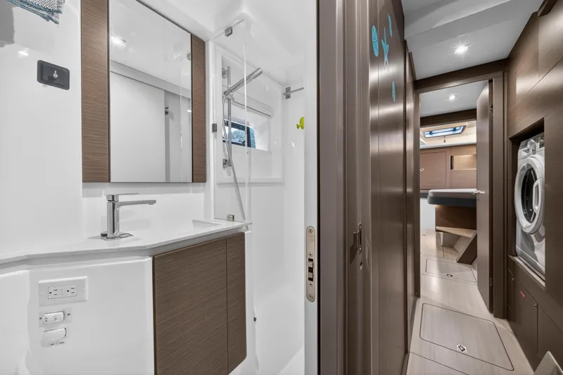 Slide: The Image of Luxurious bathroom and hallway in 2024 Leopard 46 Powercat yacht, featuring modern fixtures and wood accents. - 61
