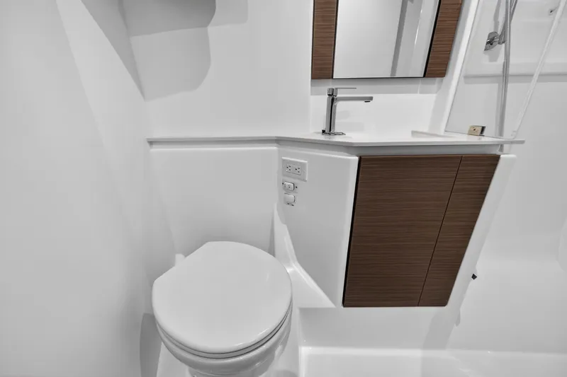 Slide: The Image of 2024 Leopard 46 Powercat bathroom with modern sink, toilet, and wooden cabinetry. - 62