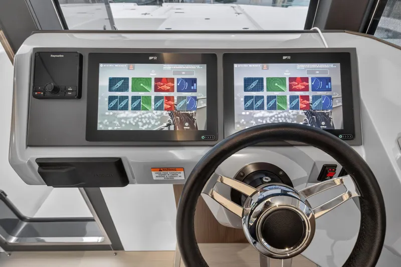 Slide: The Image of Helm of 2024 Leopard 46 Powercat with dual touchscreen displays and steering wheel. - 87