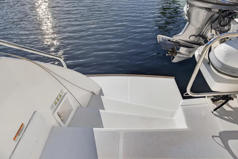 Slide: The Image of 2024 Leopard 46 Powercat boat steps leading to water with motor. - 89