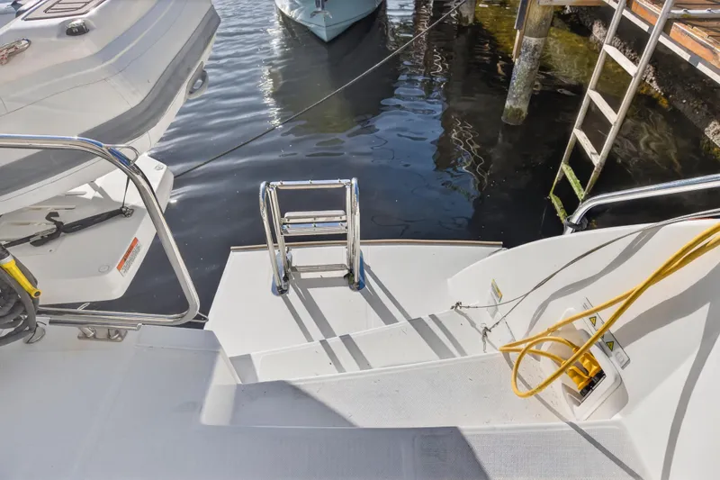 Slide: The Image of 2024 Leopard 46 Powercat swim platform with ladder and dock view. - 90