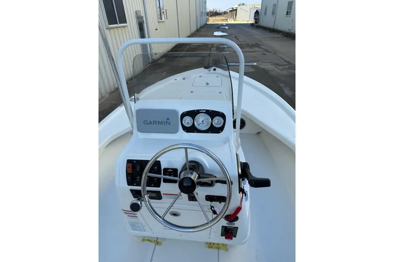 Slide: The Image of 2024 Mako 18 LTS boat console with Garmin navigation and steering wheel. - 17