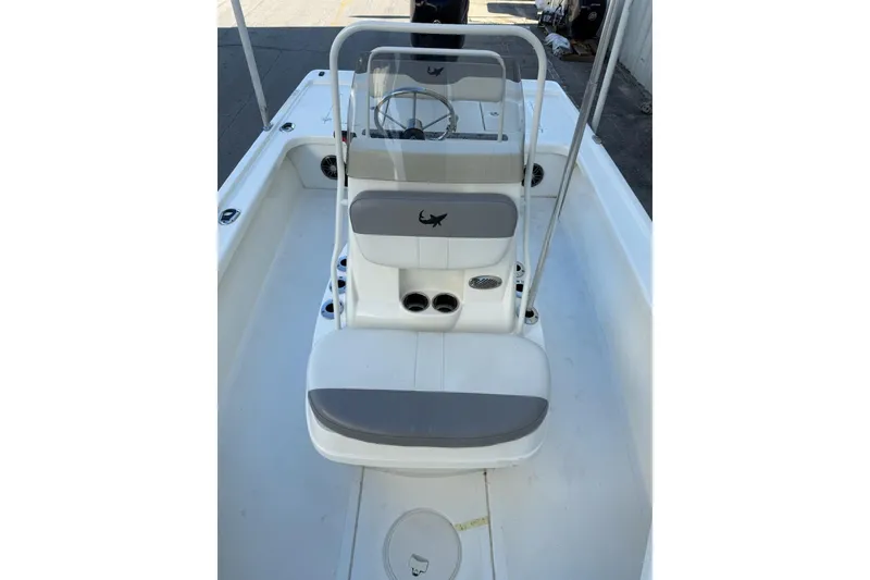 Slide: The Image of 2024 Mako 18 LTS boat interior with steering console and seating. - 18