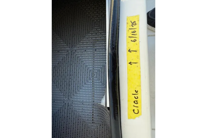 Slide: The Image of Crack on 2024 Mako 18 LTS boat with yellow tape marker. - 19