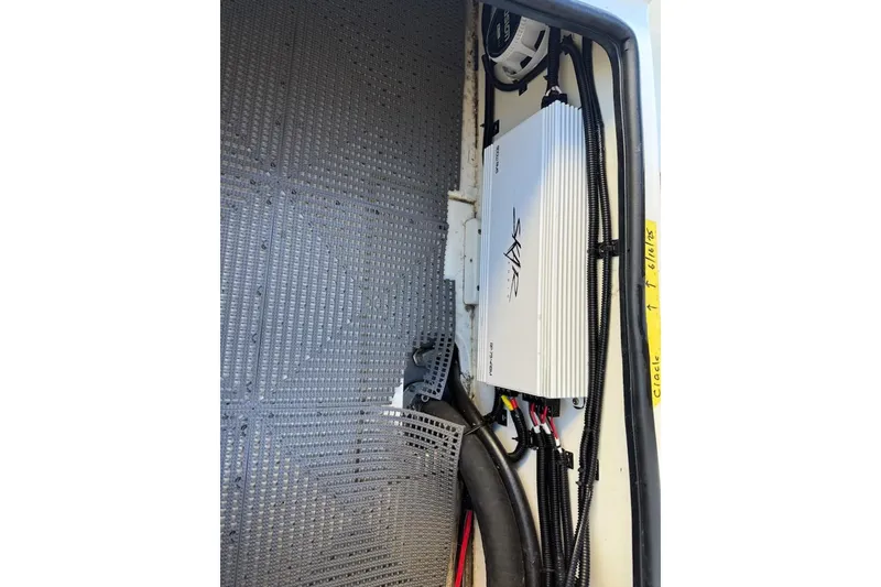 Slide: The Image of 2024 Mako 18 LTS boat interior showing electronic components and wiring setup. - 20