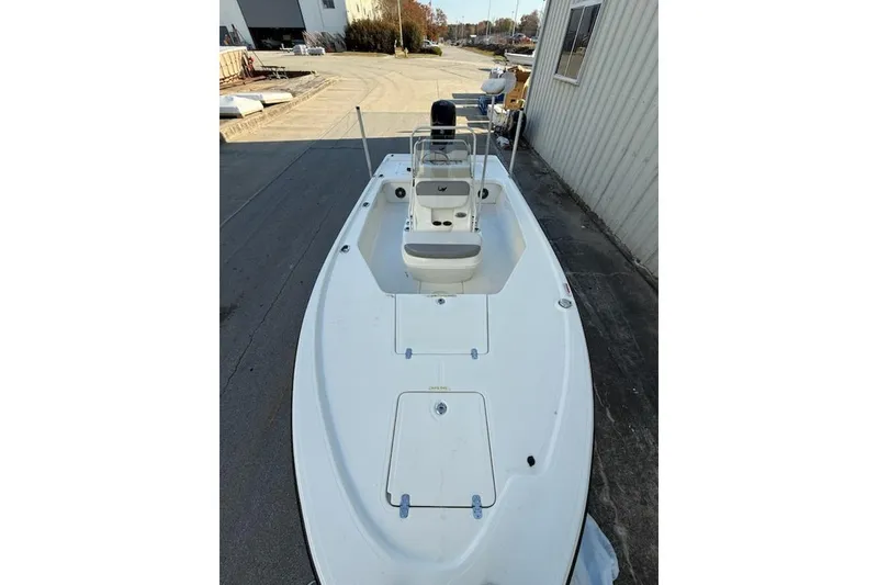 Slide: The Image of 2024 Mako 18 LTS boat, white deck, parked outdoors near a building. - 3