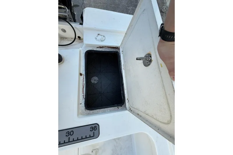 Slide: The Image of Open storage compartment on 2024 Mako 18 LTS boat, showing interior details. - 6