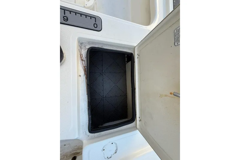 Slide: The Image of Open storage compartment on 2024 Mako 18 LTS boat, featuring textured interior. - 7