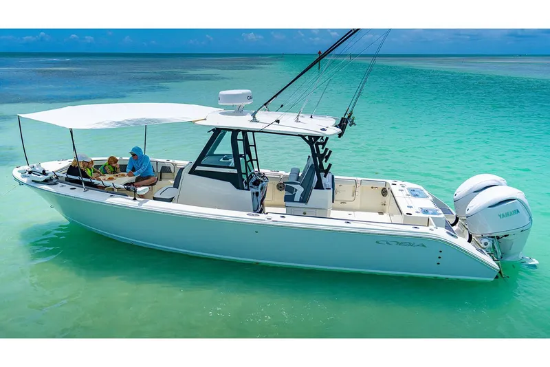 Slide: The Image of Manufacturer Provided Image: 2026 Cobia 305 Center Console boat on turquoise water, featuring Yamaha engines. - 3