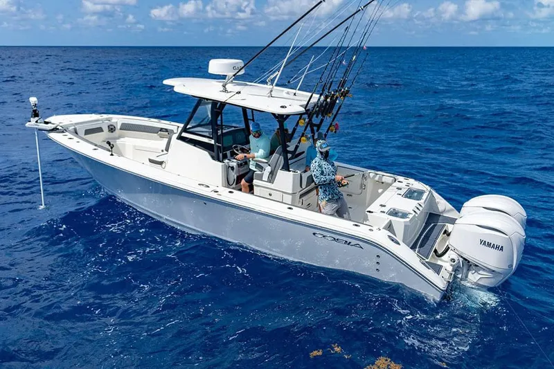 Slide: The Image of Manufacturer Provided Image: 2026 Cobia 305 Center Console boat on open ocean, equipped for fishing. - 4