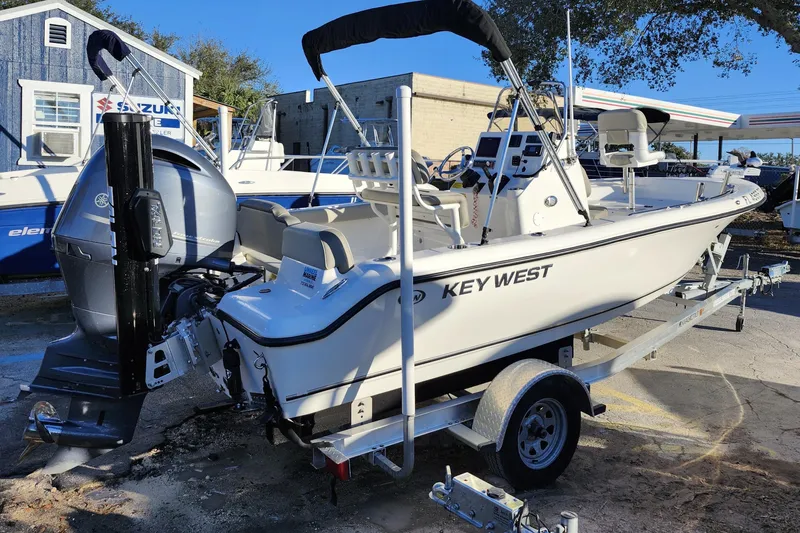 Slide: The Image of 2022 Key West 189 FS boat on trailer, parked outdoors near dealership. - 10