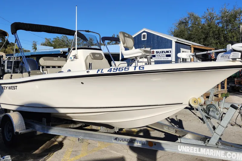Slide: The Image of 2022 Key West 189 FS boat on trailer at Suzuki Marine dealership. - 11