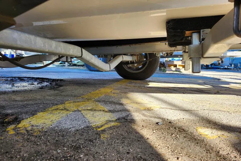 Slide: The Image of Underneath view of a 2022 Key West 189 FS boat trailer on pavement. - 12