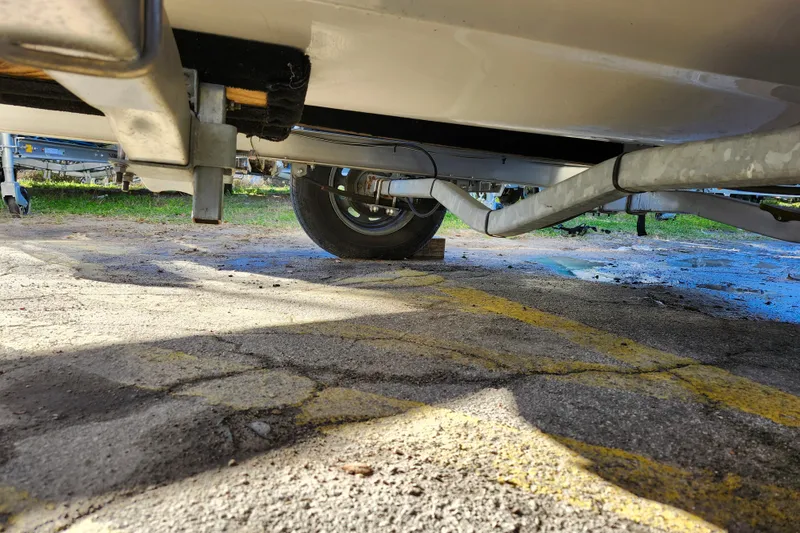 Slide: The Image of Underneath view of a 2022 Key West 189 FS boat trailer on pavement. - 13