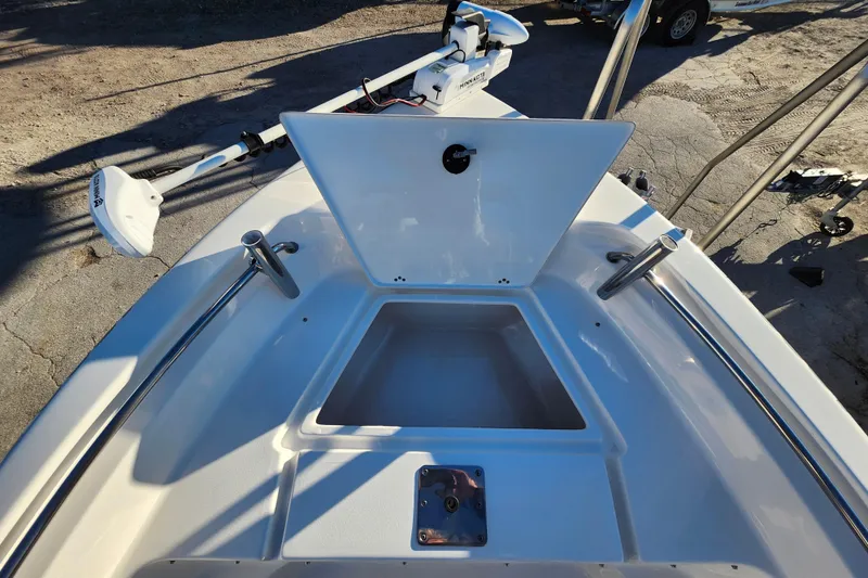 Slide: The Image of 2022 Key West 189 FS boat with open storage compartment and trolling motor. - 16