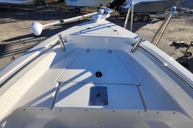 Slide: The Image of 2022 Key West 189 FS boat deck with trolling motor and storage compartment. - 17