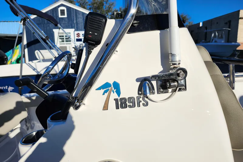 Slide: The Image of 2022 Key West 189 FS boat console with steering wheel and radio. - 24
