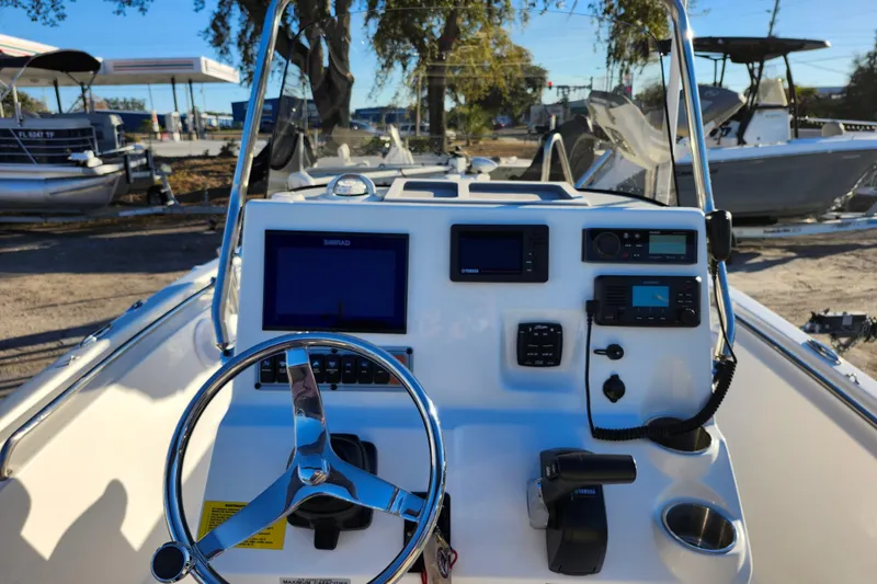 Slide: The Image of 2022 Key West 189 FS boat dashboard with steering wheel and electronic controls. - 25