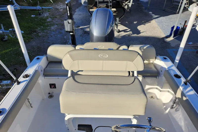 Slide: The Image of 2022 Key West 189 FS boat interior with beige seating and steering wheel. - 27