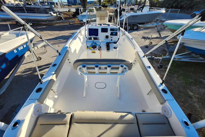 Slide: The Image of 2022 Key West 189 FS boat interior with steering console and seating, docked outdoors. - 36