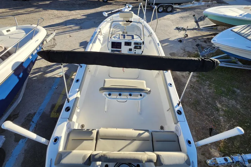 Slide: The Image of 2022 Key West 189 FS boat, top view, docked with seating and control panel visible. - 37