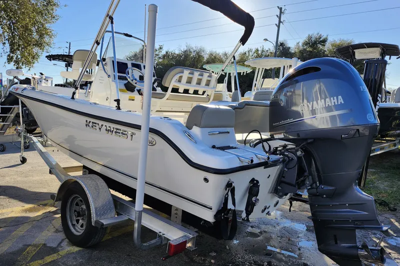 Slide: The Image of 2022 Key West 189 FS boat with Yamaha engine on trailer, parked outdoors. - 4