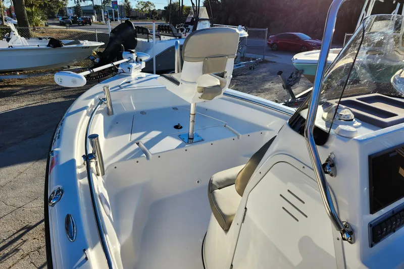 Slide: The Image of 2022 Key West 189 FS boat interior with seating and console, parked outdoors. - 41