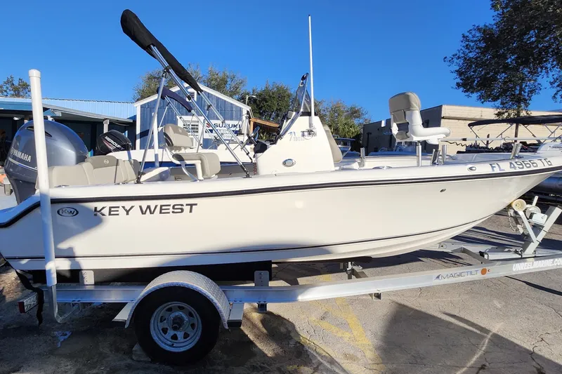 Slide: The Image of 2022 Key West 189 FS boat on trailer, featuring Yamaha engine, parked outdoors. - 9