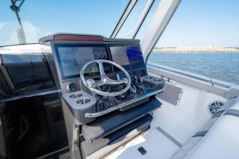 Slide: The Image of Manufacturer Provided Image: Helm of 2025 Pursuit S 428 Sport boat with advanced navigation displays. - 12
