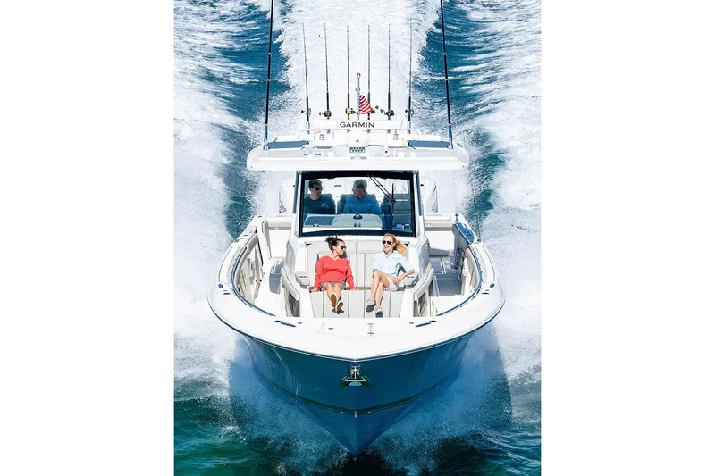Slide: The Image of Manufacturer Provided Image: 2025 Pursuit S 428 Sport boat cruising with passengers on deck. - 2