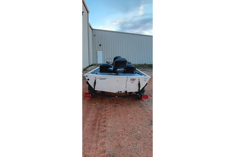 Slide: The Image of 2026 Tracker Pro 170 boat on trailer, parked near a building. - 10