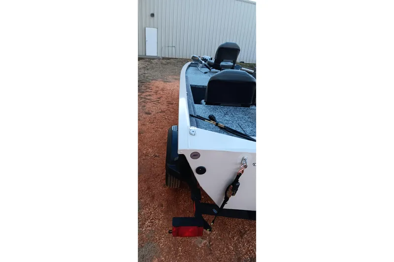 Slide: The Image of 2026 Tracker Pro 170 boat on trailer, parked outdoors near a building. - 11