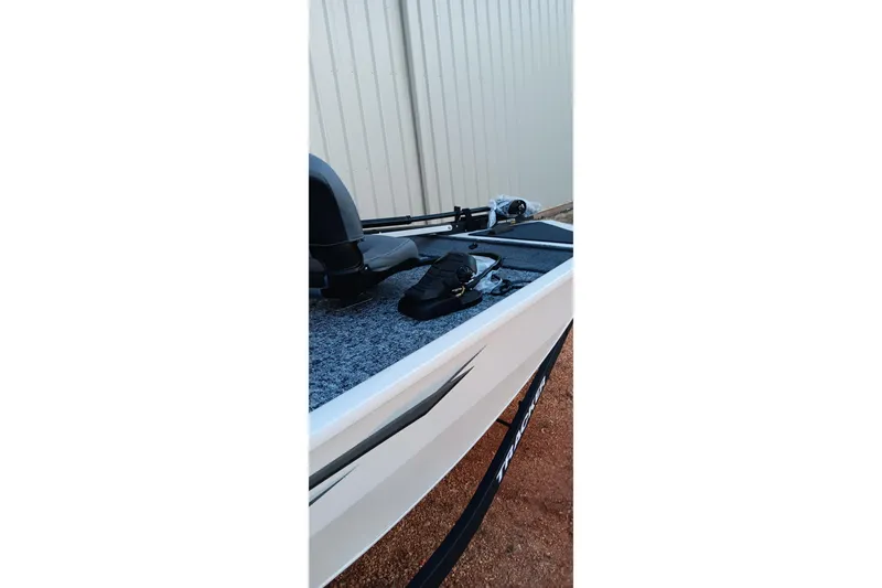 Slide: The Image of 2026 Tracker Pro 170 boat, side view, featuring deck and seating. - 13