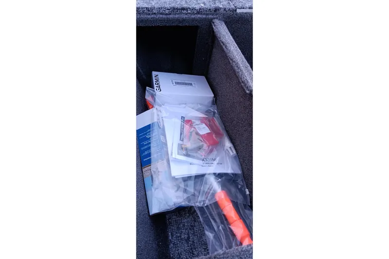 Slide: The Image of Storage compartment in 2026 Tracker Pro 170 boat with manuals and accessories. - 15