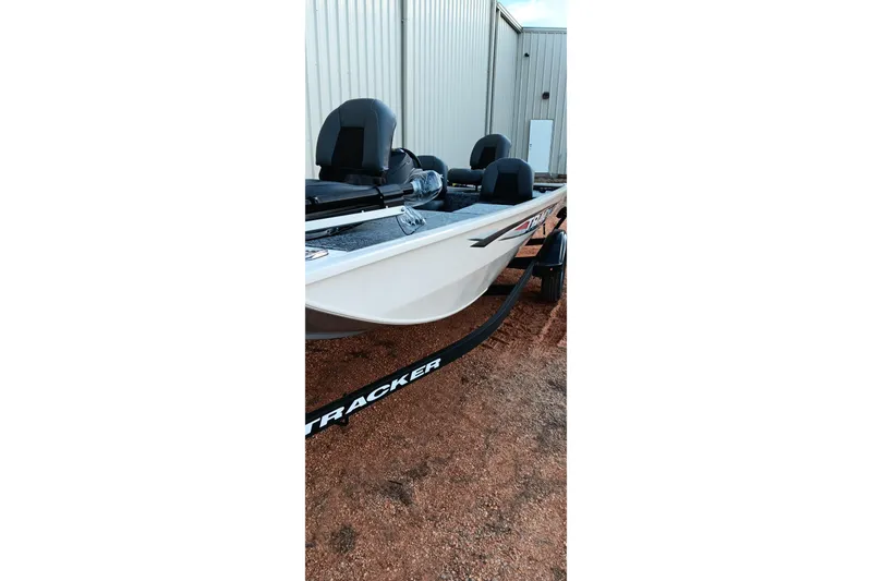 Slide: The Image of 2026 Tracker Pro 170 boat on trailer near metal building. - 3