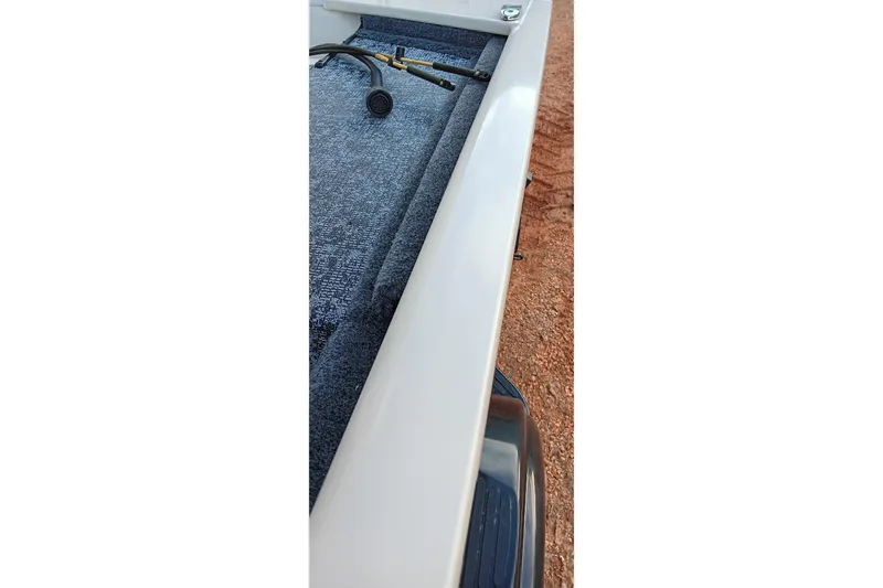 Slide: The Image of 2026 Tracker Pro 170 boat interior with carpeted flooring and equipment. - 6