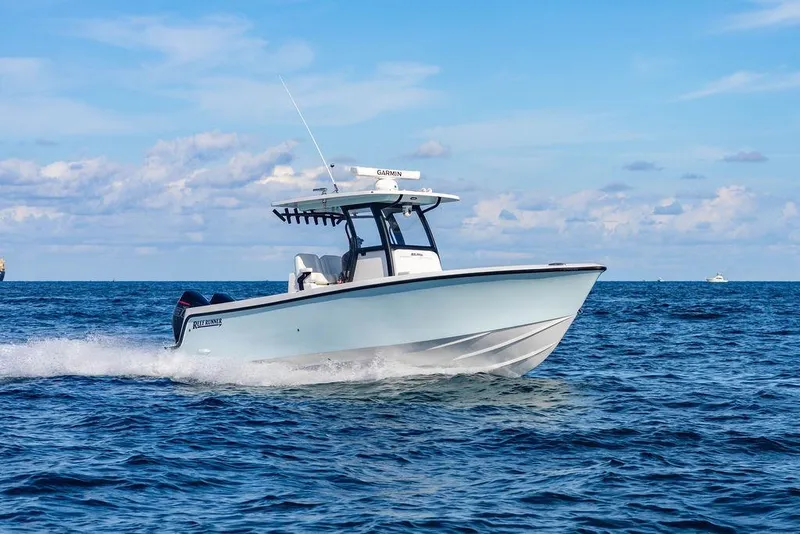 Slide: The Image of 2026 Reef Runner 280 boat cruising on open ocean under clear blue sky. - 11