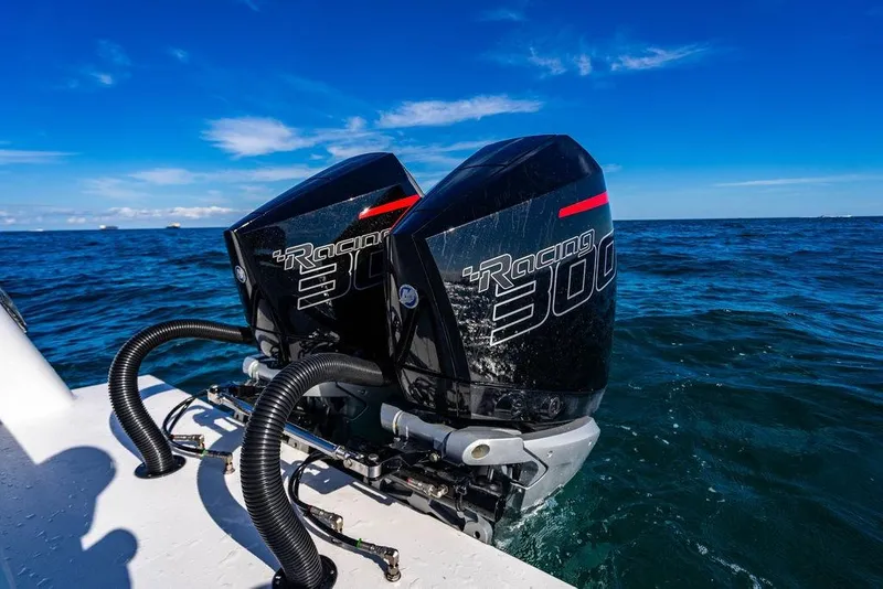 Slide: The Image of Twin Racing 300 outboard motors on 2026 Reef Runner 280 boat in open sea. - 13
